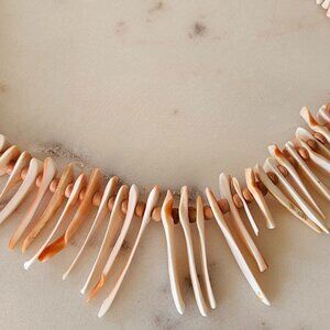 Shell Spike Necklace made from Apricot and White colored shells. Twist clasp